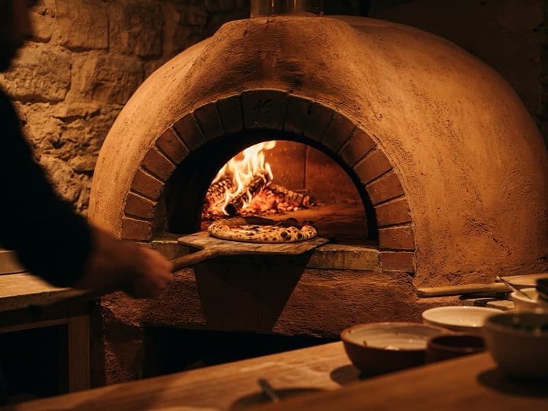 Wood-fired pizza oven in action