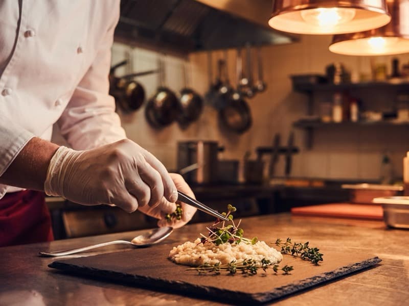 Chef preparing a dish in the kitchen